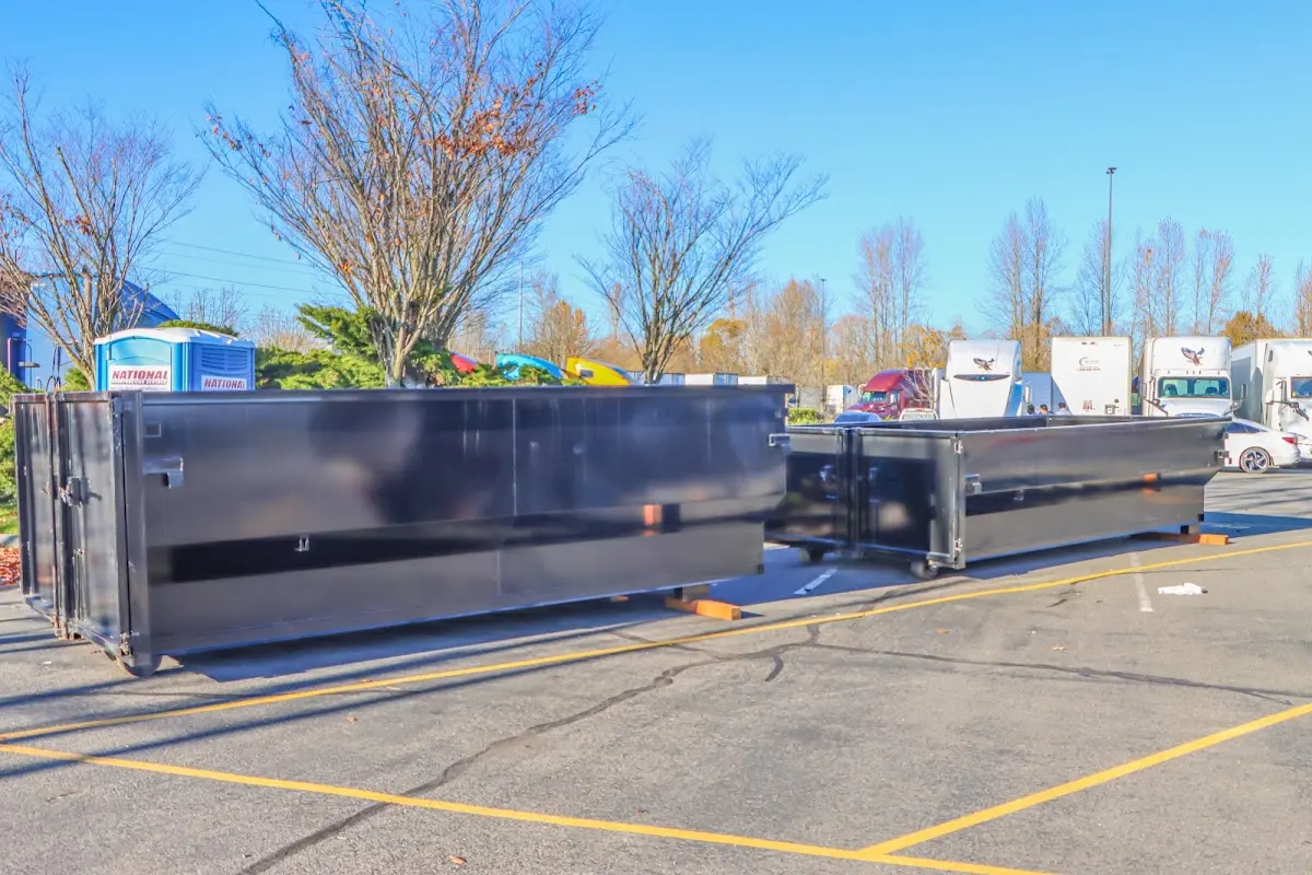 Professional dumpster rental service with roll-off container on residential driveway in Kosciusko